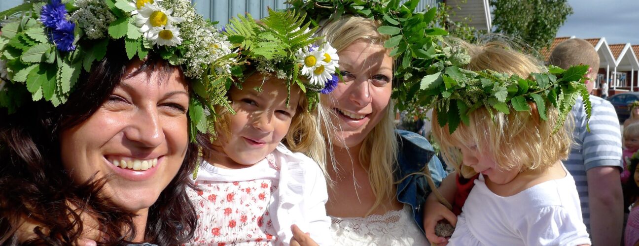 En glad familj som firar midsommar på camping i Västkusten.